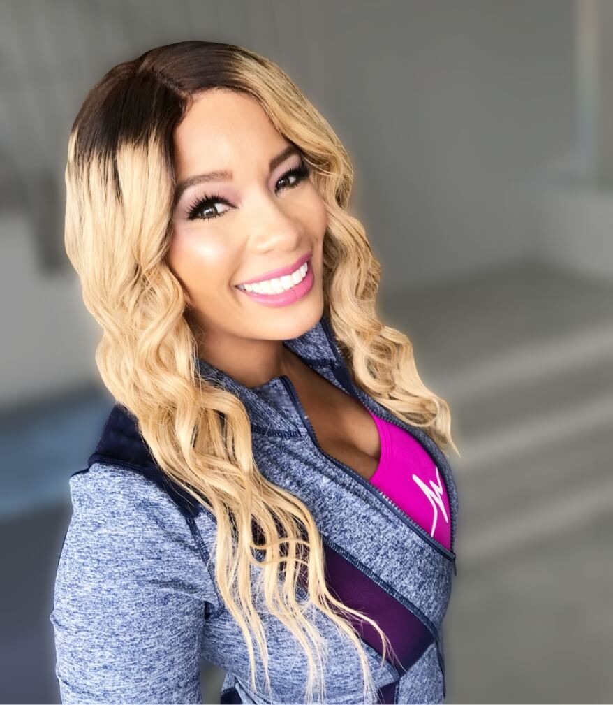 Kwanza Jones smiles wearing pink and grey athletic clothing Kwanza Jones smiles wearing pink and grey athletic clothing